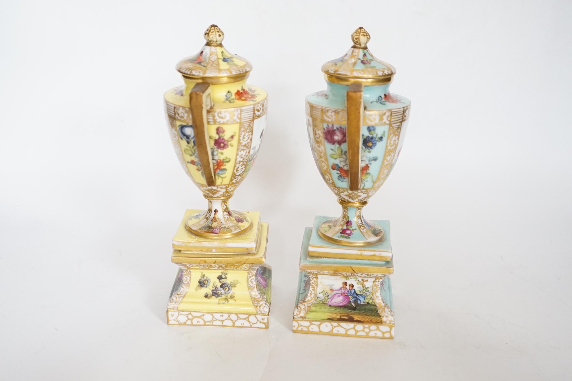 A pair of Dresden porcelain vases and covers (restored) together with a hen egg basket and cover, largest 19cm high (3)